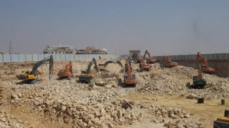 Mass excavation under way at BeauRivage Plaza, with a fleet of excavators breaking rock across the site