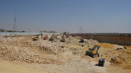Graded sand and broken rock across the BeauRivage Plaza excavation